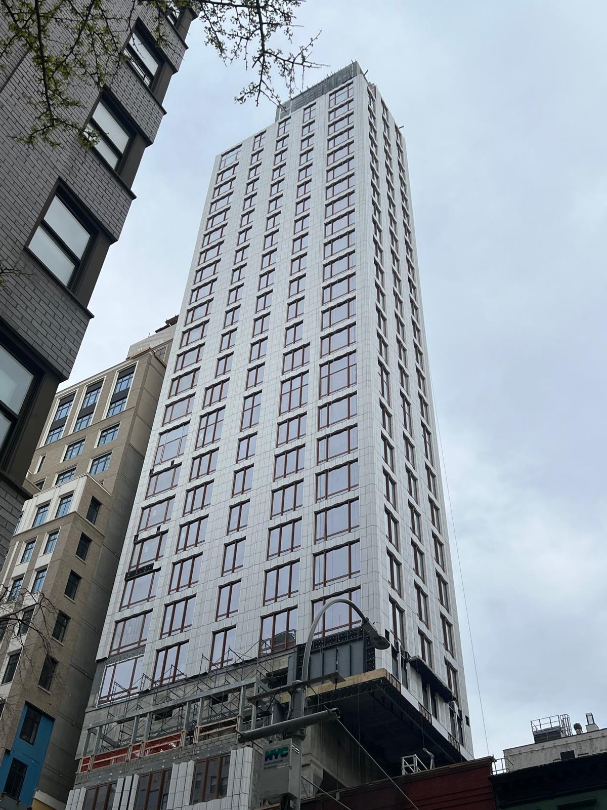 Completed stone facade and window installation at 1299 3rd Avenue